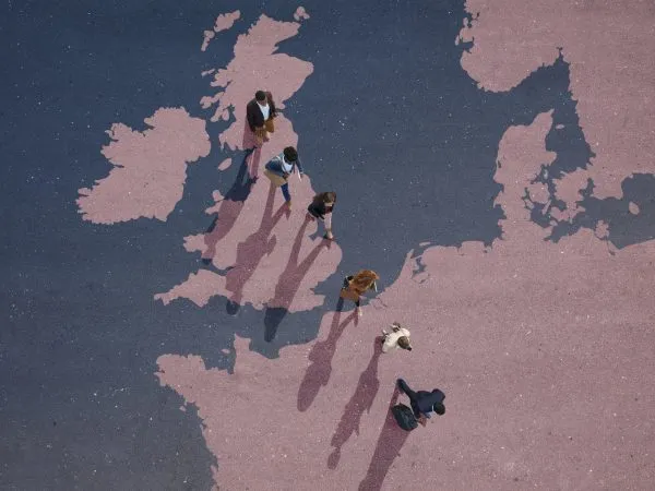Group of young adults, photographed from above, on various painted tarmac surface, at sunrise.